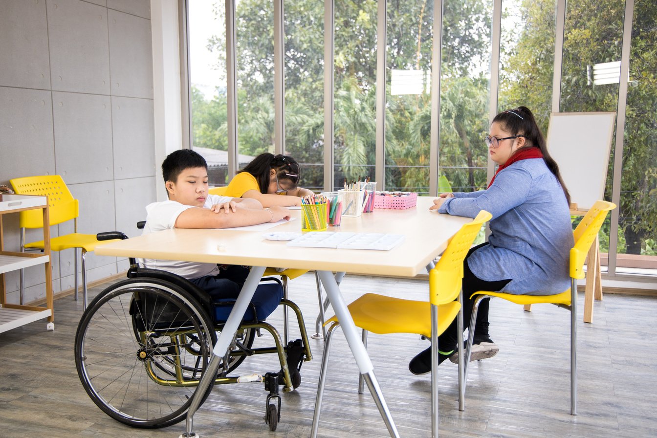 Group of disabled children in classroom.